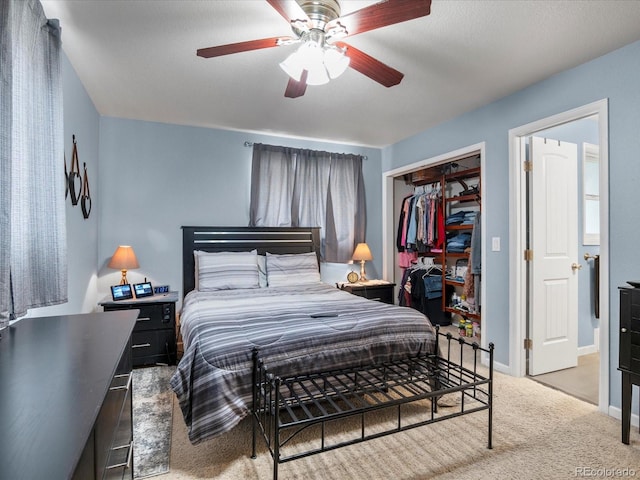 carpeted bedroom featuring a closet and ceiling fan