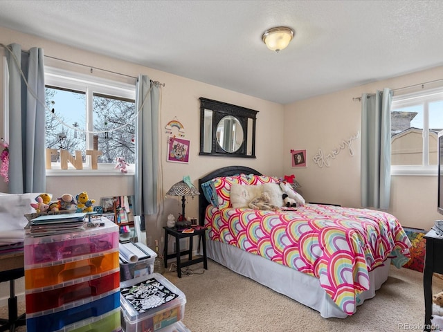 bedroom featuring a textured ceiling and light colored carpet