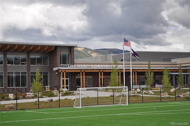 view of tennis court featuring a mountain view