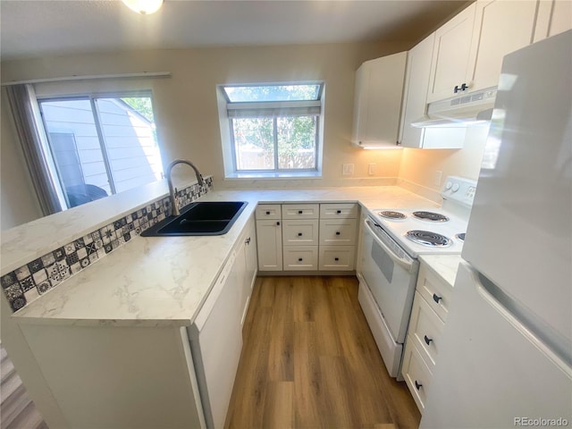 kitchen featuring light wood-type flooring, sink, white cabinets, and white appliances