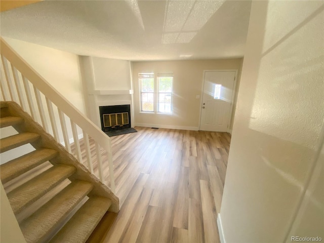 unfurnished living room with hardwood / wood-style floors