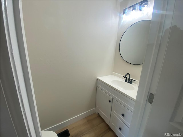 bathroom with hardwood / wood-style flooring and vanity