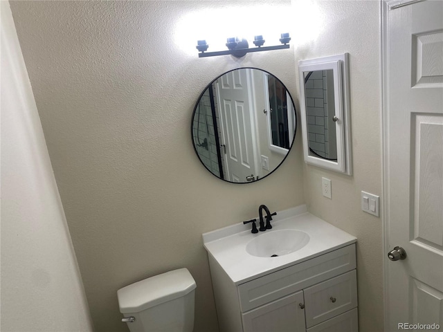 bathroom with toilet and vanity