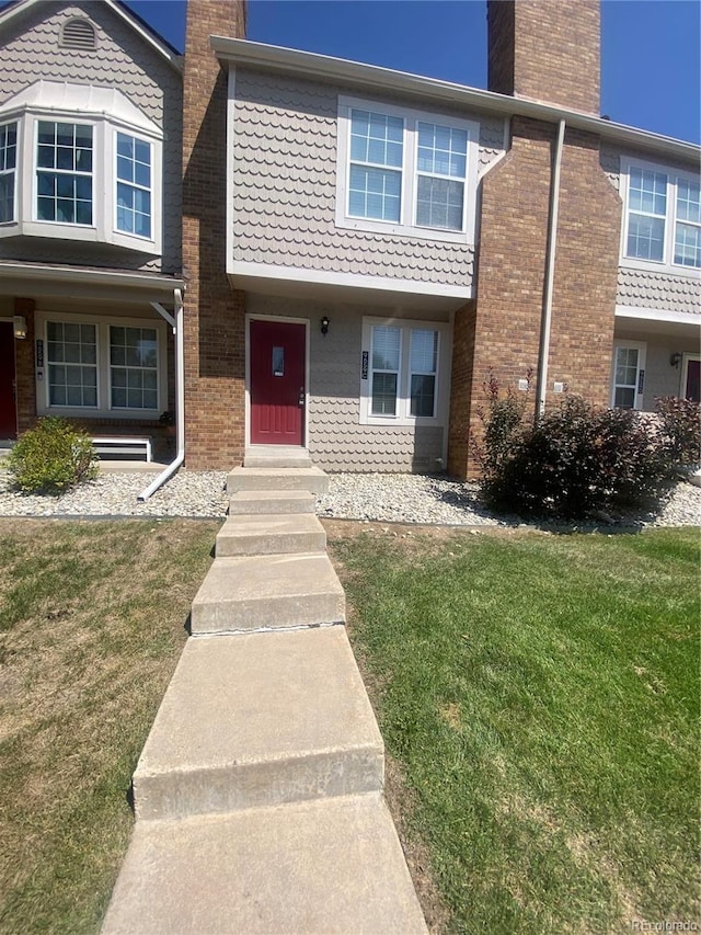 view of property featuring a front lawn