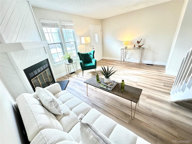 living room featuring hardwood / wood-style flooring and a textured ceiling