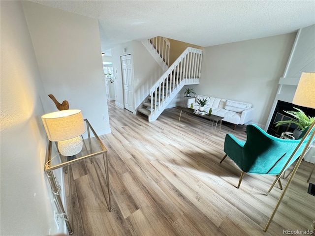 interior space featuring a textured ceiling and light wood-type flooring