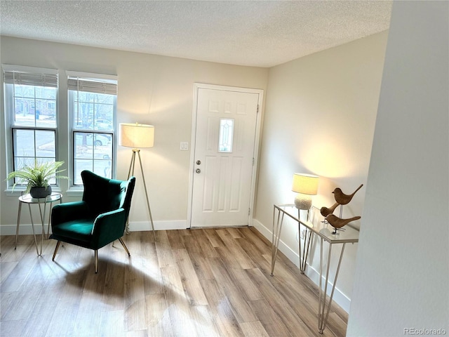 entrance foyer featuring light hardwood / wood-style flooring and a textured ceiling