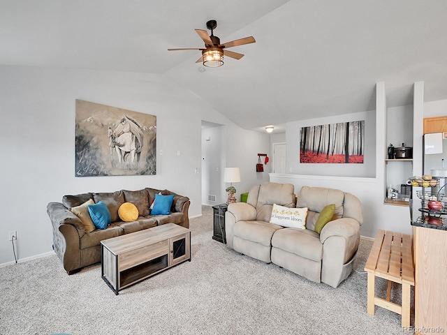 living area featuring baseboards, carpet flooring, a ceiling fan, and lofted ceiling