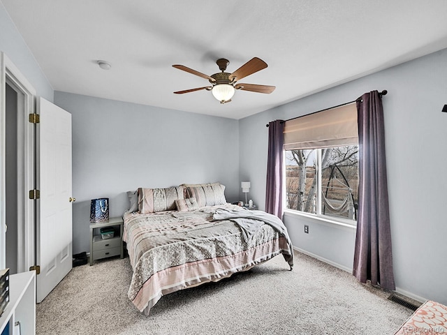 bedroom with light carpet, visible vents, a ceiling fan, and baseboards