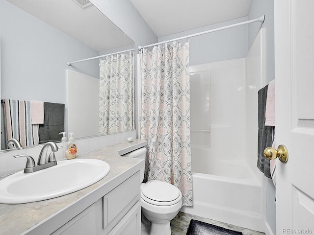 bathroom featuring vanity, toilet, and shower / bath combo with shower curtain