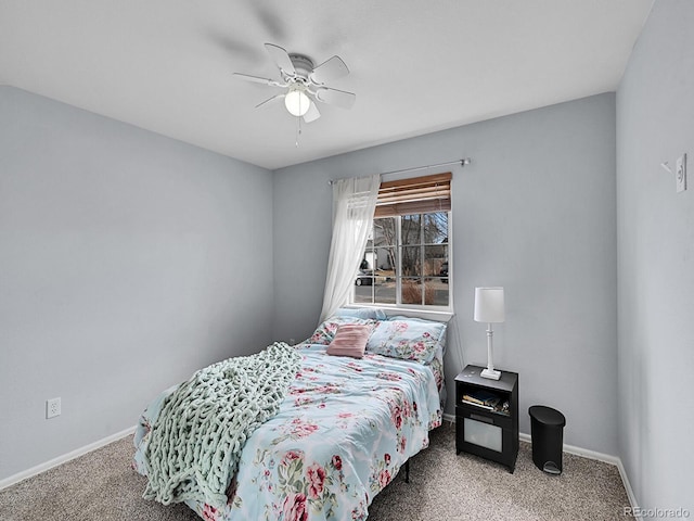 carpeted bedroom with ceiling fan and baseboards