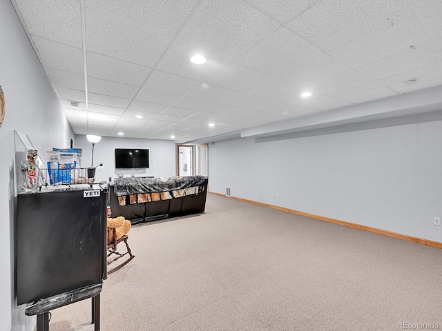 carpeted living area with visible vents, recessed lighting, baseboards, and a drop ceiling