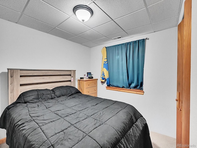 bedroom featuring a drop ceiling and visible vents