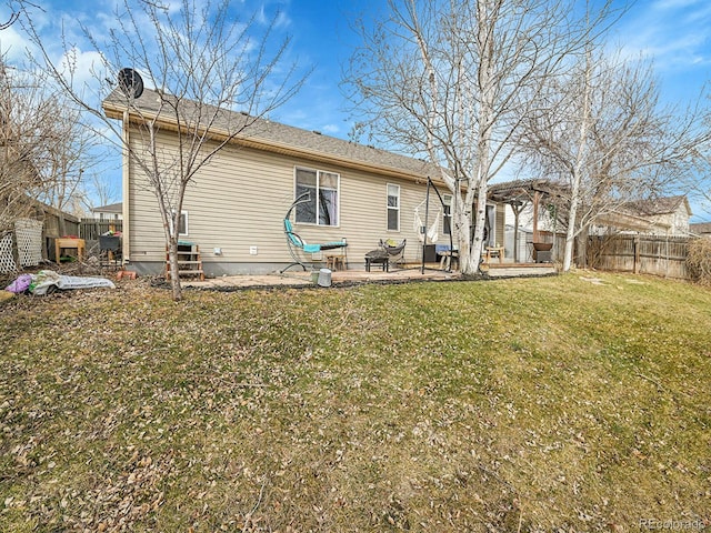 rear view of property with a lawn, fence private yard, a pergola, and a patio area