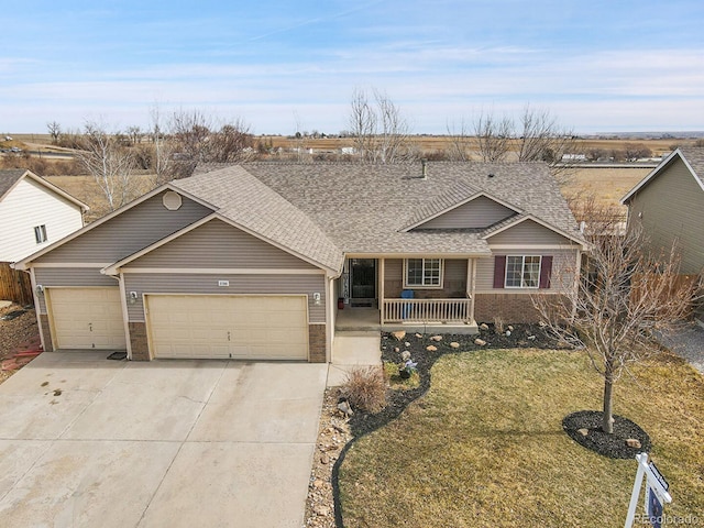 single story home with a front yard, roof with shingles, a porch, an attached garage, and concrete driveway