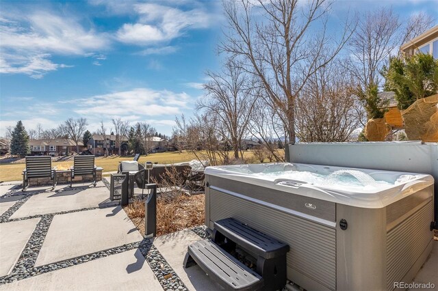 view of yard featuring a patio area and a hot tub