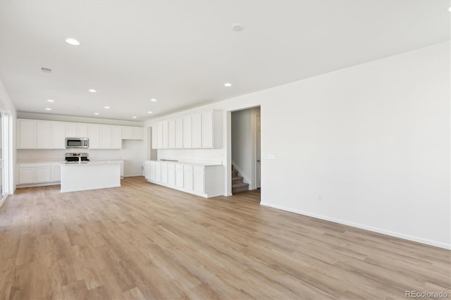 unfurnished living room featuring light wood-type flooring