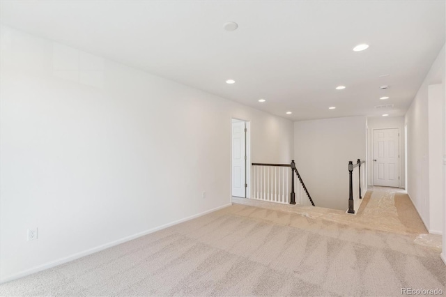 unfurnished room with light colored carpet