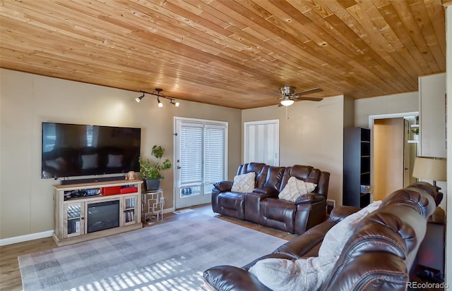 693 E Ave, Limon, CO 80828 - living area with ceiling fan, a fireplace, wood finished floors, wooden ceiling, and baseboards