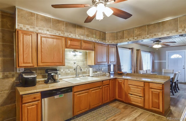 693 E Ave, Limon, CO 80828 - kitchen with stainless steel dishwasher, a peninsula, light wood-style floors, ceiling fan, and a sink