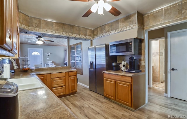 693 E Ave, Limon, CO 80828 - kitchen featuring brown cabinets, ceiling fan, a sink, light wood-style flooring, and stainless steel appliances