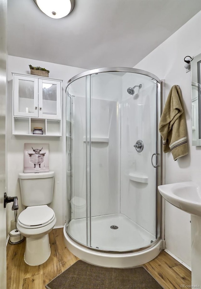 693 E Ave, Limon, CO 80828 - bathroom featuring a stall shower and wood finished floors