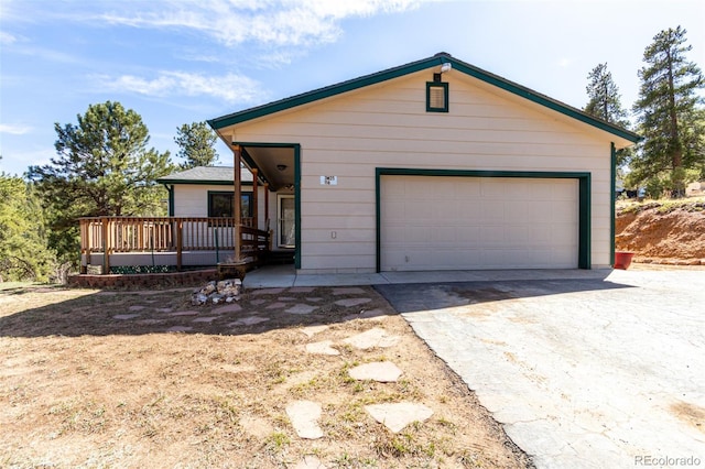 116 Schooley Rd, Bailey, CO 80421 - ranch-style home featuring a garage, a wooden deck, and driveway
