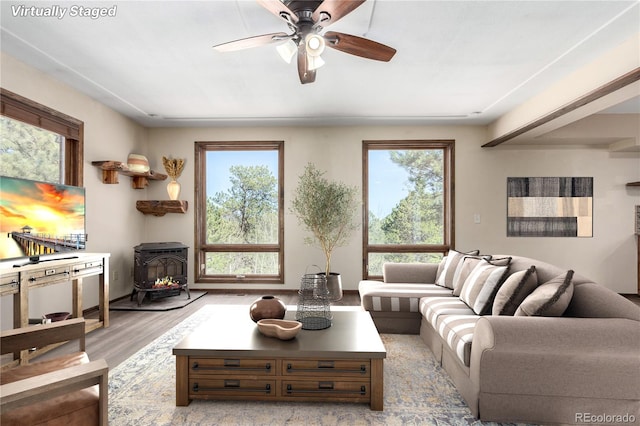 116 Schooley Rd, Bailey, CO 80421 - living area featuring a wood stove, plenty of natural light, light wood finished floors, and ceiling fan