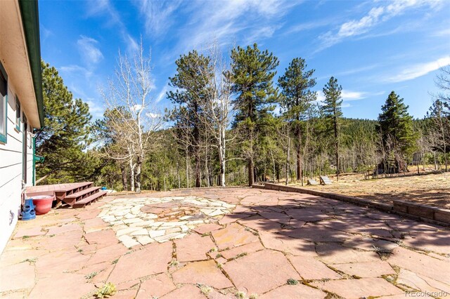 116 Schooley Rd, Bailey, CO 80421 - view of patio featuring a forest view