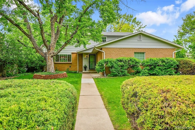 7439 S Depew St, Littleton, CO 80128 - view of front of house featuring brick siding and a front lawn