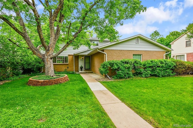 7439 S Depew St, Littleton, CO 80128 - view of front of house with brick siding and a front yard
