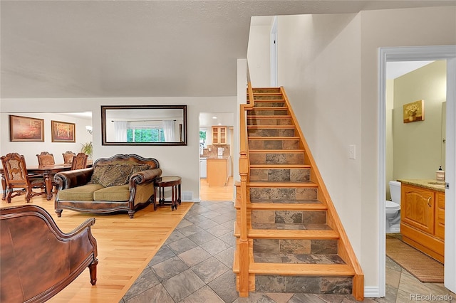 7439 S Depew St, Littleton, CO 80128 - staircase featuring stone tile flooring and baseboards