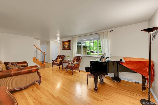 7439 S Depew St, Littleton, CO 80128 - living area with light wood-style flooring, baseboards, and stairs