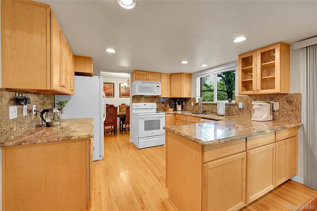 7439 S Depew St, Littleton, CO 80128 - kitchen with white appliances, light brown cabinets, a peninsula, and recessed lighting
