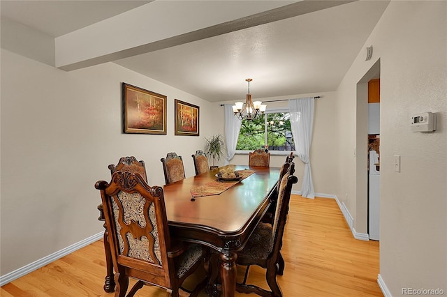 7439 S Depew St, Littleton, CO 80128 - dining area featuring a chandelier, light wood-style flooring, and baseboards