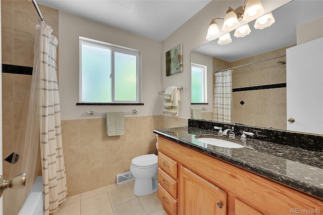 7439 S Depew St, Littleton, CO 80128 - bathroom featuring tile walls, tile patterned floors, vanity, toilet, and shower / tub combo with curtain