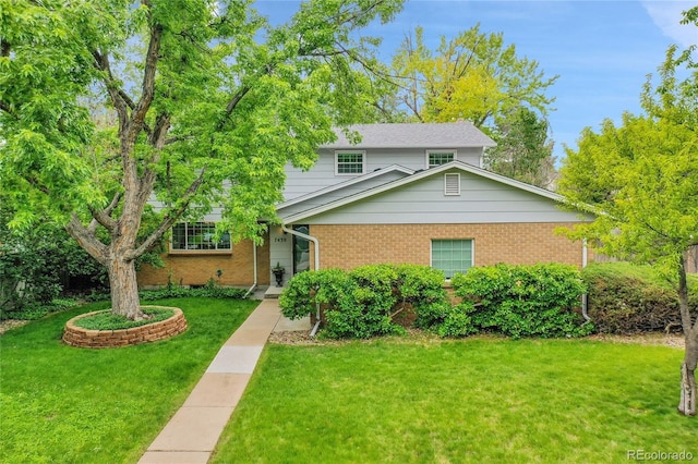 7439 S Depew St, Littleton, CO 80128 - view of front of home featuring a front yard and brick siding