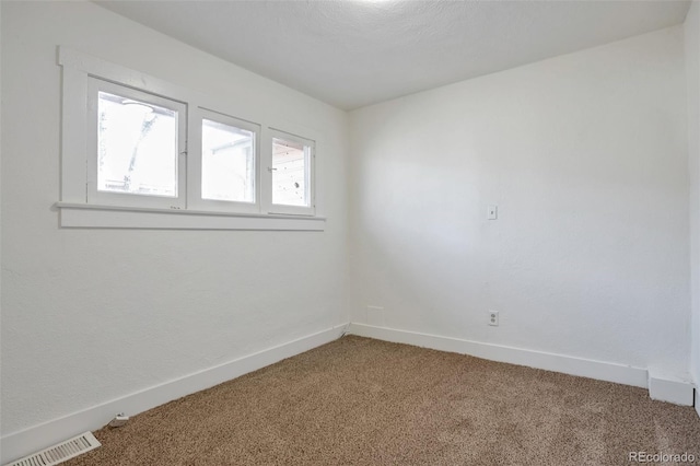 unfurnished room featuring carpet flooring