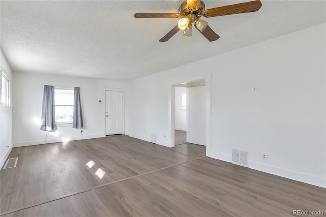 empty room featuring hardwood / wood-style floors and a textured ceiling