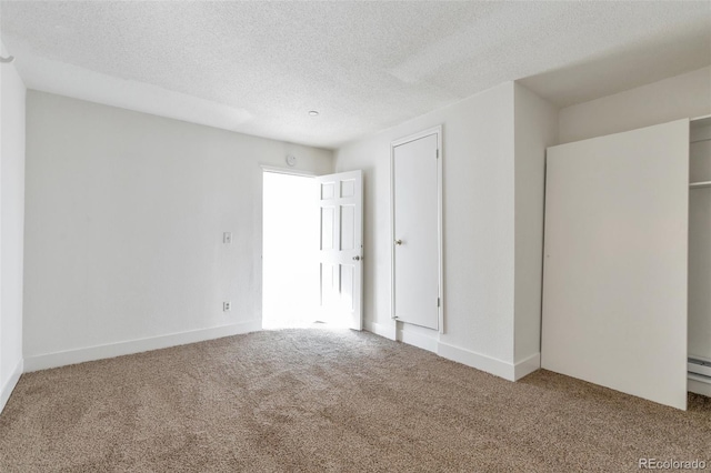 unfurnished bedroom featuring carpet floors and a textured ceiling