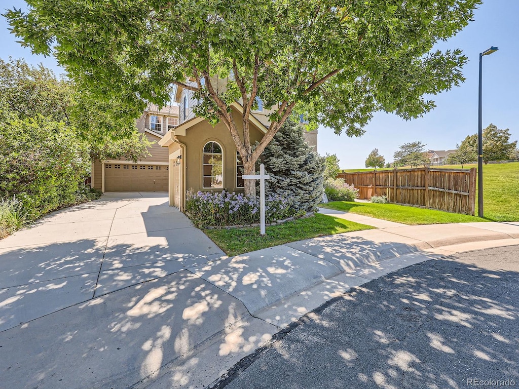 view of front of home with a front lawn and a garage