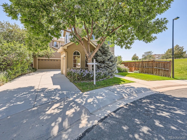 view of front of home with a front lawn and a garage