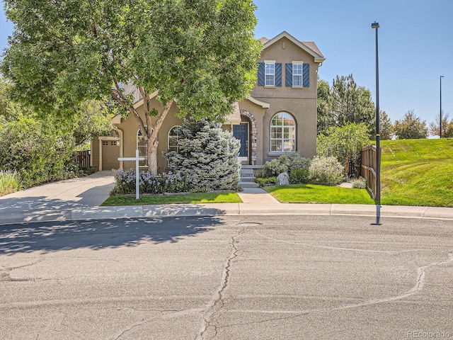 view of front of home featuring a front lawn and a garage