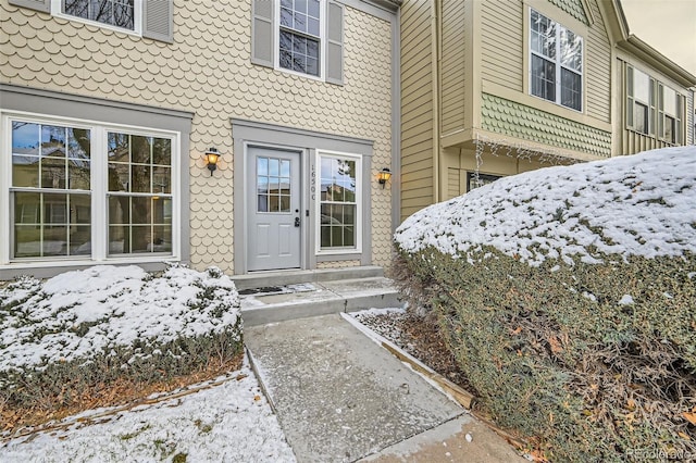 view of snow covered property entrance