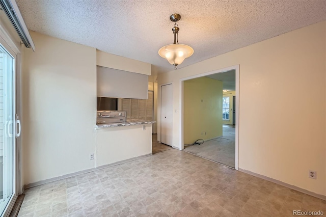 unfurnished living room with a textured ceiling