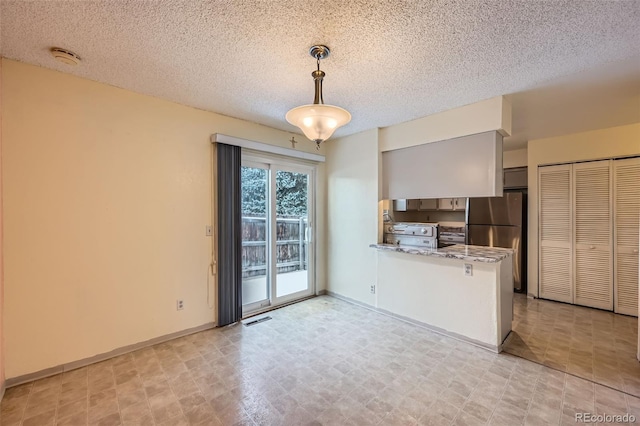 kitchen with kitchen peninsula, light stone countertops, a textured ceiling, stainless steel appliances, and hanging light fixtures