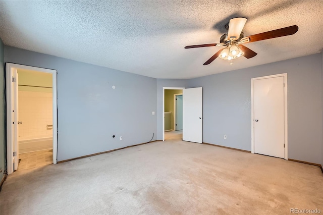 unfurnished bedroom with ensuite bath, ceiling fan, light colored carpet, and a textured ceiling