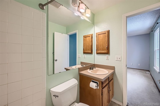 bathroom featuring vanity, toilet, and a textured ceiling