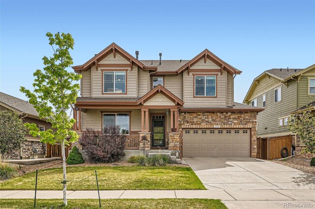 350 N Langdale Ct, Aurora, CO 80018 - craftsman inspired home with an attached garage, driveway, covered porch, and stone siding