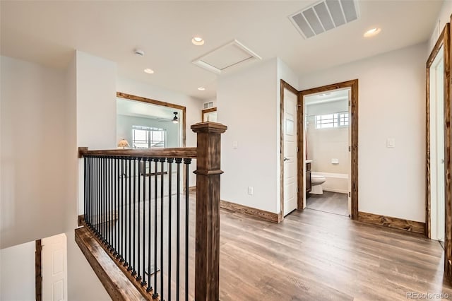 350 N Langdale Ct, Aurora, CO 80018 - corridor with wood finished floors, baseboards, attic access, recessed lighting, and an upstairs landing